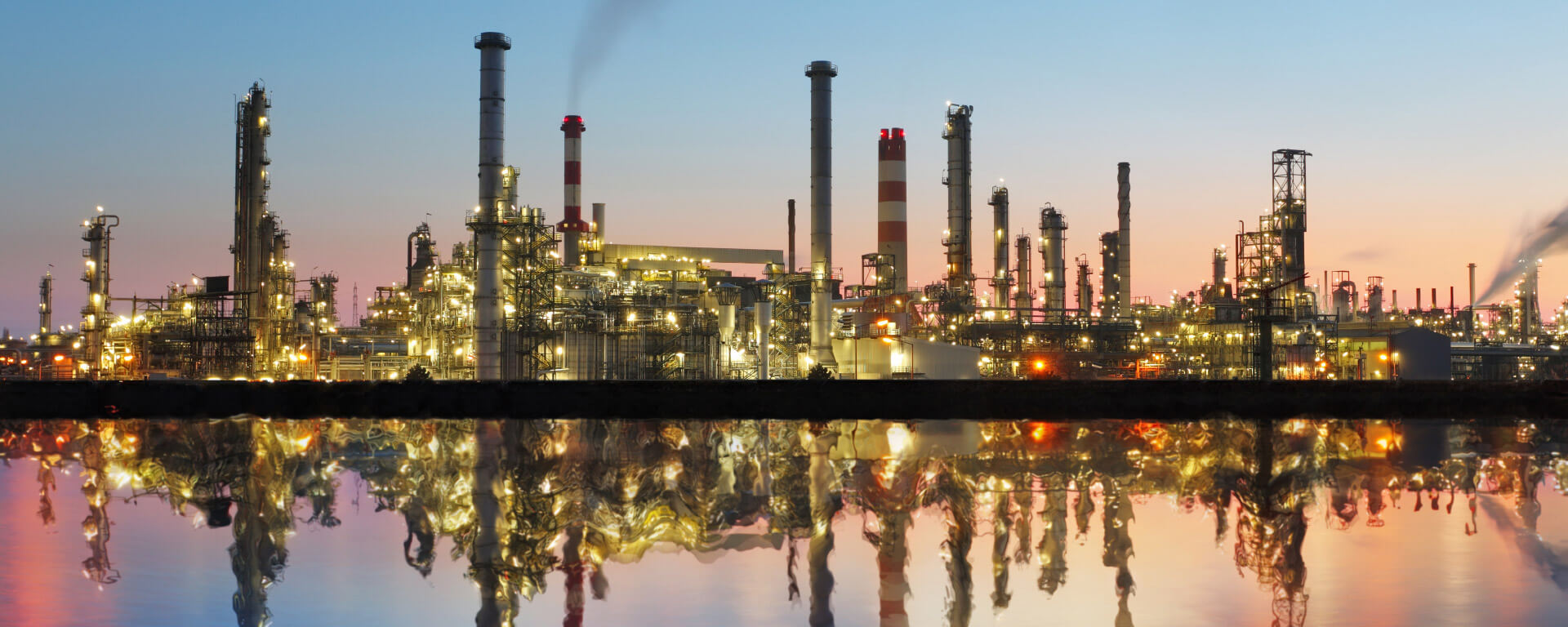 Industrial plant in sunset reflected in the water